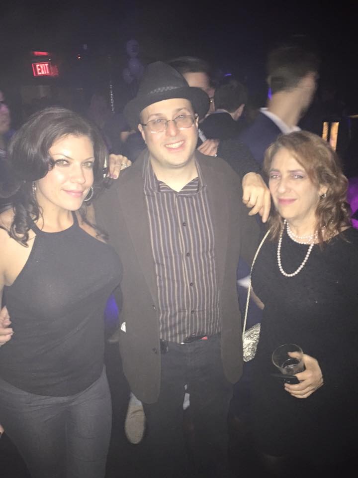 Three people posing together at an event