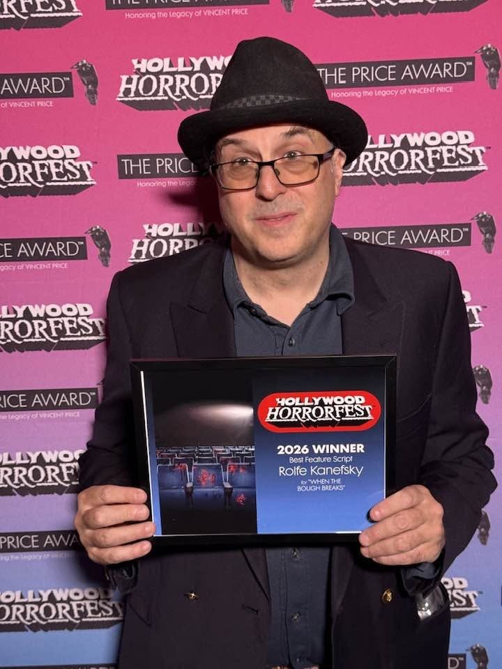 Rolfe Kanefsky holding the Hollywood Horrorfest 2026 Best Feature Script award for When the Bough Breaks